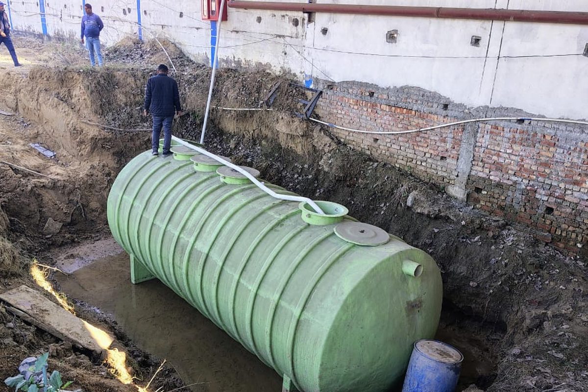 Underground sewage treatment tank being set into its pit